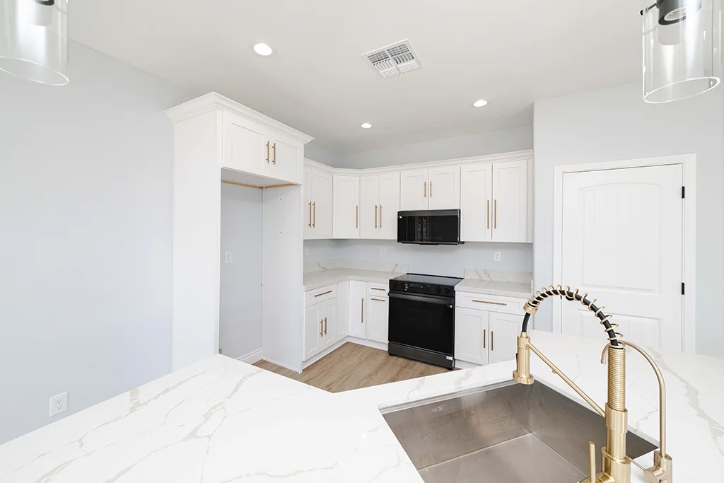 Quartz countertops and gold faucet upgrade in a Kingman AZ kitchen remodel