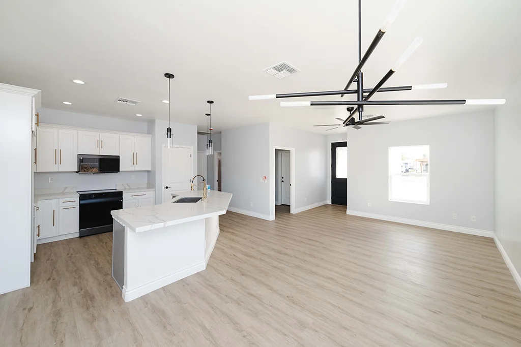 Open layout kitchen and living room remodel in Kingman AZ with modern lighting
